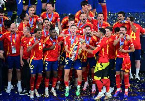 Spain don complete a perfect competition by beating England 2-1 to lift a record fourth European Championship.